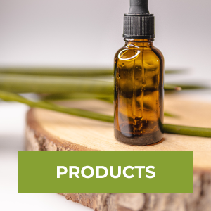Vial of oil on a wooden prop with greenery in the background. There is a Products button on the image.
