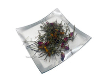 Load image into Gallery viewer, A small clear plate that contains a sampling of the tea/assortment of herbal ingredients found in the Just Fine tea.
