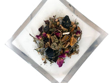 Load image into Gallery viewer, A glass plate with a silver border shows a more detailed view of the herbal ingredients.
