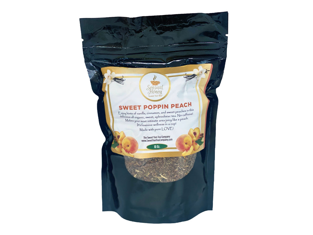 A sealed, black bag of Sweet Poppin Peach Tea featuring a small clear window to view the tea ingredients. The label of the bag is decorative and features images of peaches and vanilla.